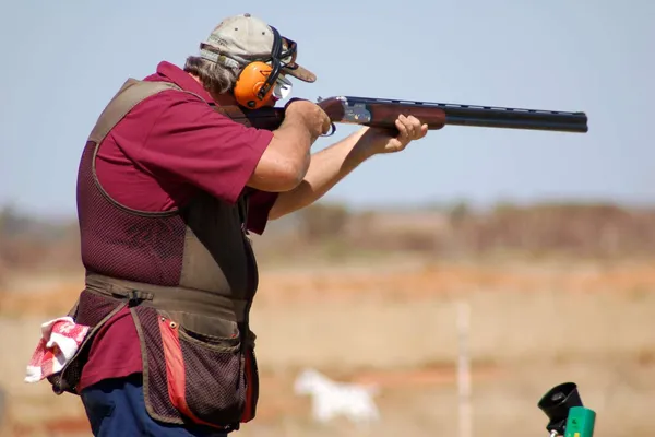 Clay target shooter in action.